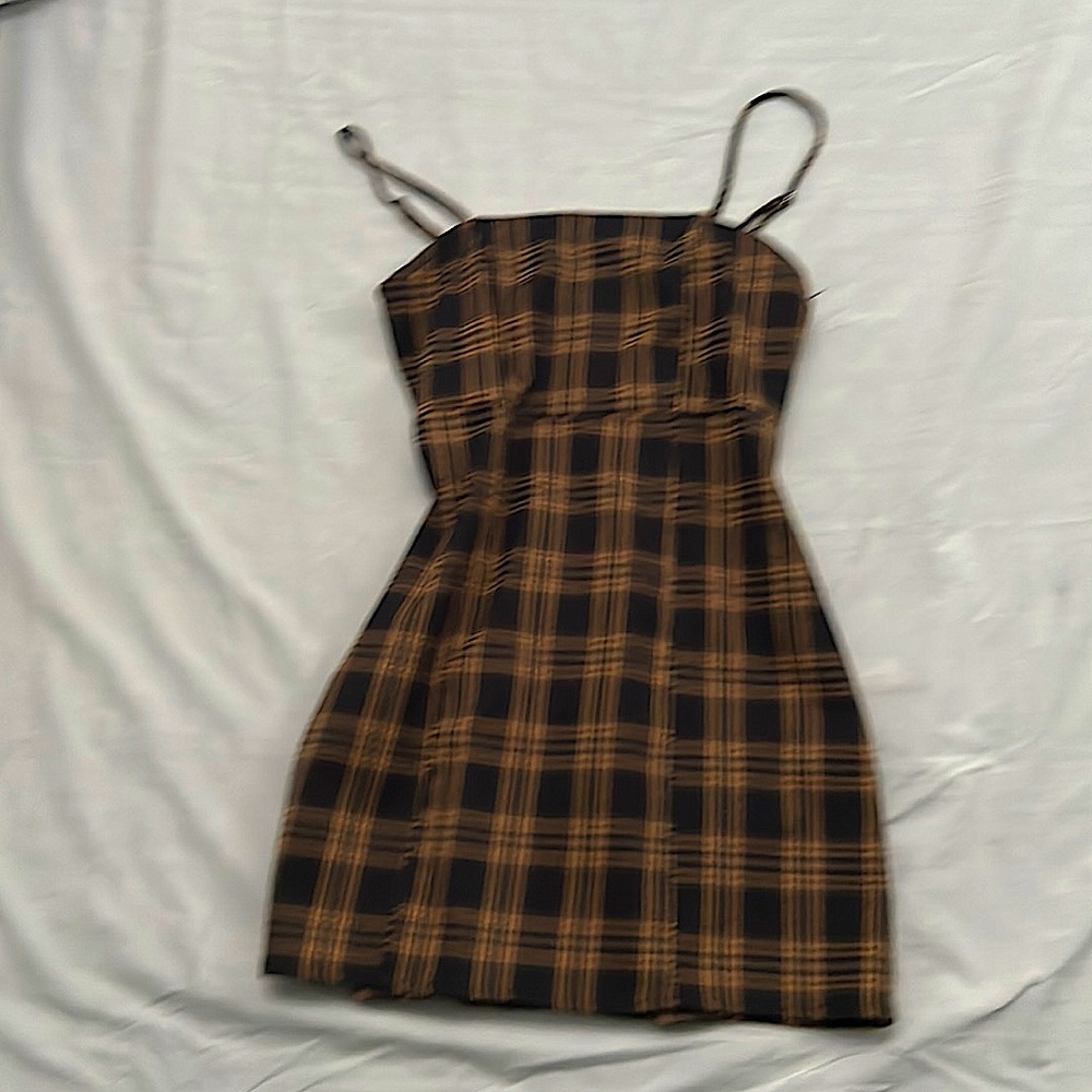 Brown plaid mini dress with adjustable spaghetti straps.